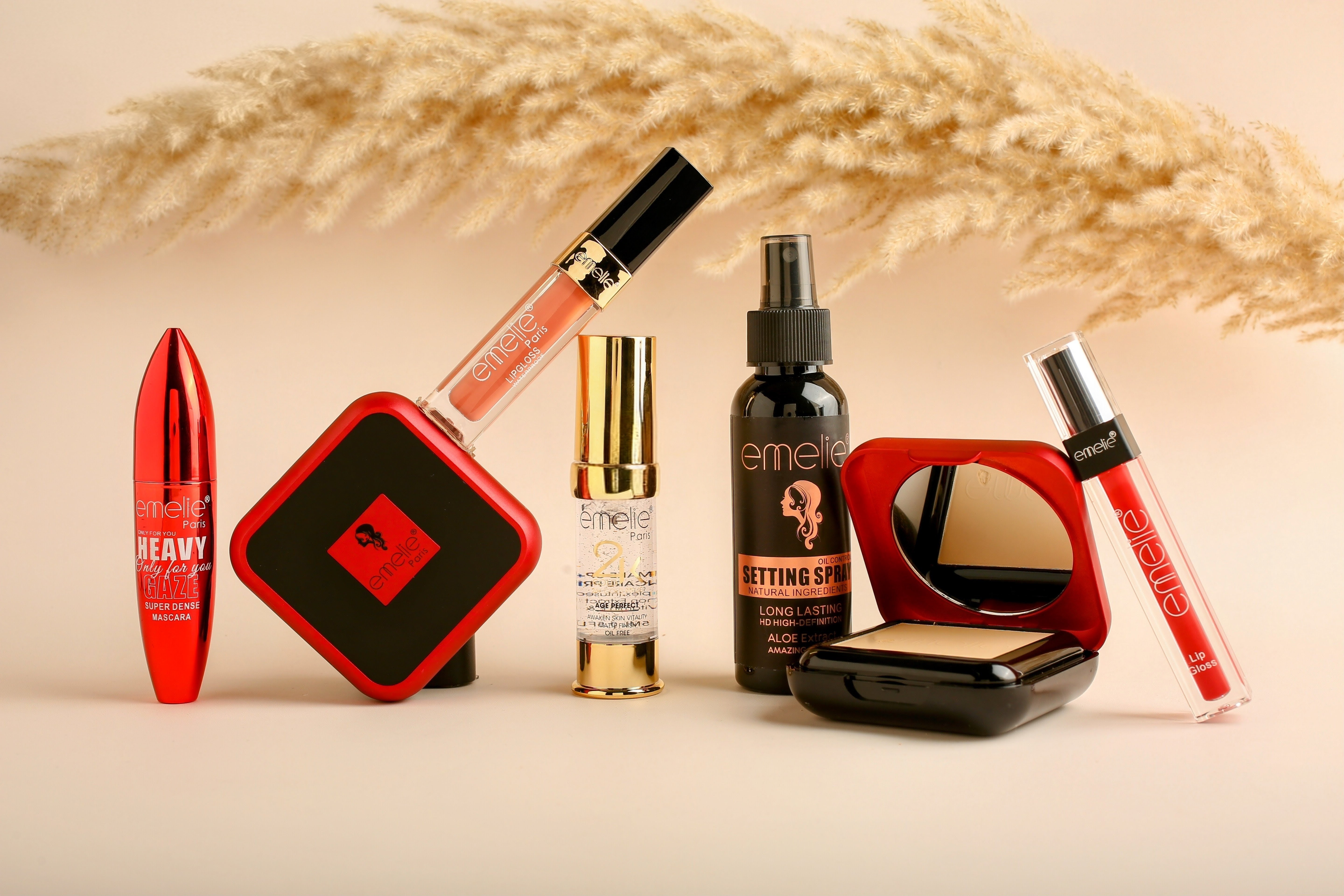 Makeup products including foundation, compact, and setting spray arranged creatively
